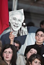 Tbilisi, georgia, march 24, 2008, opposition supporter holds a picture of late businessman badri patarkatsishvili during a protest outside the parliament building in tbilisi, in support of opposition ...