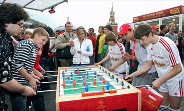 Teenagers playing a game of foosball in red square, moscow, the venue of the 2008 uefa champions festival, moscow, russia, may 2008.