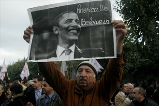 Georgian opposition supporter holds up a portrait of us president-elect, barak obama, inscribed with 'america we believe in' during a protest in capital tbilisi, georgia, november 7, 2008.