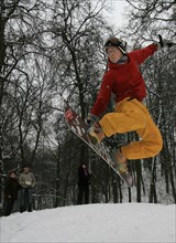 Snowboarder jumps during the 3rd moscow family alpine skllng fest on vorobyevy (sparrow) hills, moscow, russia, february 8, 2009.