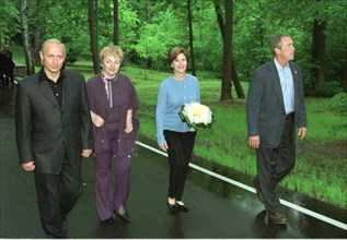 U,s, president george w, bush (r), first lady laura (2r), russian president vladimir putin (l) and his wife lyudmila (2nd l) pictured strolling in the grounds of the presidential residence at novo-oga...