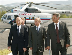 Kemerovo region,russia, august 29, russian president vladimir putin (c) flanked by director general of the raspadskaya coal mine gennady kozovoi (l) and kemerovo governor aman tuleyev heading for the ...