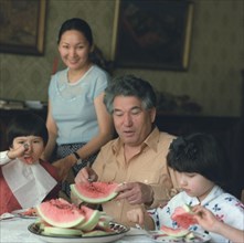 Famous kirghiz writer chinghiz aitmatov with his family: wife maria, daughter shirin, 8, and son eldar, 6, september 1985.