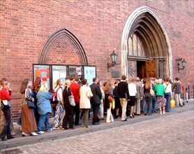 People standing in line to buy tickets for a musical-theatrical performance in the dom cathedral, riga, latvia, 2003.