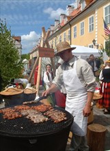 Shashliks of chicken-meat and pork are roasted on the grates of cast-iron pans, different types of smoke products cooked on cast-iron pans are national meals of latvia, folk festival, riga, latvia, 20...