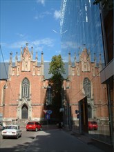 Riga, latvia, 2003, the lutheran gertruda's church in baznicas street beside a modern multi-storey car park, park.