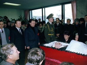 Chairman of state duma ivan rybkin standing center behind coffin at funeral in chita of deputy to the state duma sergey markidonov, killed by hired gunmen on november 26 in the city of petrovsk-zaball...