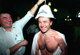 Russian banya fan yevgeny serebrennikov (center) looks happy getting an original hot sauna cap as a present from rifat khalilulin, a worker at the famous sandunovsky banyas in moscow, russia, 2003.