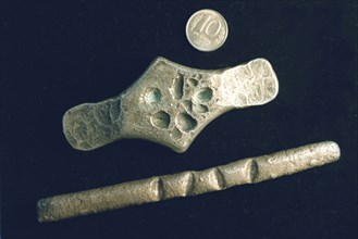 Currency of medieval russian, top: a modern ten rouble coin, center:  silver grivna of chernigov region 12-13th century, bottom: silver grivna of western russian type (lithuanian) 12-14th century.