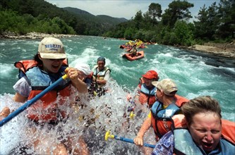 Russian tourists enjoying white-water rafting near antalya in turkey which in recent years has become a popular vacation destination.