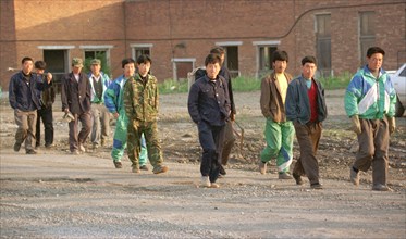 Chinese workers are heading to a construction site in the city of ussurllsk (russian far east) early in the morning, maritime territory,russia,october 12 1998, due to the recent economic crisis in rus...