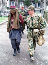 Drug trafficking - tajikistan, october 6, 2002, an afghani man (l) shown being detained by a border guard of the pyandzhsky border detachment, a big batch of heroin weighing 138,5 kilograms, which had...