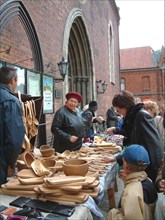 Woman selling handicrafts at the traditional autumn fair outside the dom cathedral in old riga.