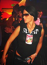 Fashionable young latvian woman dancing at nautilus a popular night club in riga's old city, latvia, 2003.