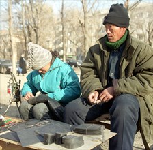 Chinese shoemakers in nakhodka, far east, russia, 2/02.