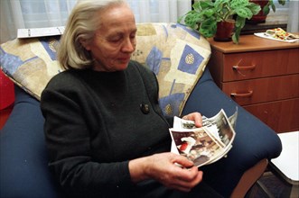 Yekaterina shkrebneva, mother-in-law of the russian acting president vladimir putin, looking through photos from the family album, january 2000, for 40 years she has lived in kaliningrad in an old 3-s...