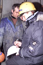 Surgut,russia, march 3 2000, acting president vladimir putin signs an autograph for an oil worker during his visit to a drilling station near the western siberian city of surgut, (itar-tass photo/ ser...