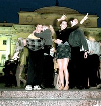 Russian school graduates dance all night on the admiralty quay in saint petersburg, russia, 2003.