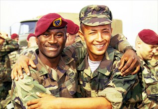 Kazakhstan, september 11, 2000, kazakh  paratrooper azamat gazizov (r) and his new american friend ngoku uchechukwu (l), exercises of the peace-keeping batallion 'centrasbat-2000'
