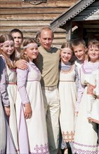 Karelia, russia, august 21 2001, president vladimir putin, on vacation here, pictured among the participants of a folklore group, on the famous island of kizhi in the onega lake, at the outdoor museum...