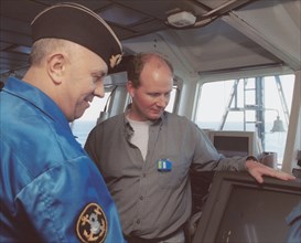 Barents sea, july 19 2001, head of diving work sean popple (r) and head of the team of russian divers gennady verich (r) aboard the mayo ship, located in the barents sea over wrecked sub 'kursk', russ...