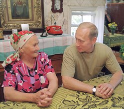 Petrozavodsk, karelia, russia, august 19 2001, president vladimir putin who spends his vacation in karelia pictured talking with maria stepanova in the village of yamki,on saturday , he saw the interi...