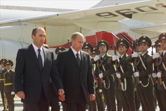 Russian president vladimir putin (r) and his armenian counterpart robert kocharyan (l) inspecting guard of honour upon the arrival of russian head of state at the airport of yerevan on friday sept, 14...