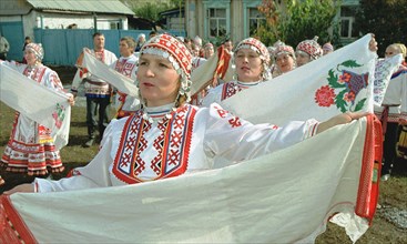 members of a chuvash folk dance ensemble performing at a folk festival in the village of zubovo, bashkiria, russia, october 2001.