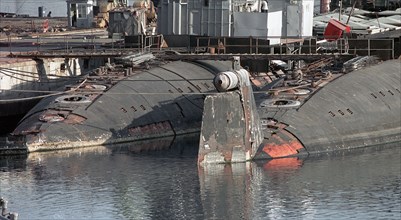 Maritime territory, russia, november 24 2001: two decommissioned nuclear powered submarines at the pier of the zvezda shipyard