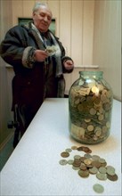 Omsk, russia, 2/02, glass jars filled with banknotes of 1993-1995 and coins of 1961-1996 are brought by residents of this siberian city to saving banks to change them for the present-day currency, one...