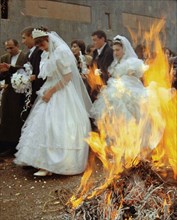 Brides and bridegrooms heading for the church blessing on valentine's day, february 14, in yerevan, armenia, 2/14/02, newly weds who jump over a campfire three times are believed to be healthy and wea...