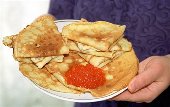 Russia 10/02, traditional russian cuisine: crepes (blini) with red caviar.