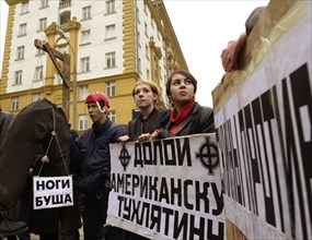 Moscow, russia, march 22 2002: participants of a rally in front of the american embassy protesting import of chicken leg quarters from the u,s,a, about a dozen youngsters took part in the rally, the p...