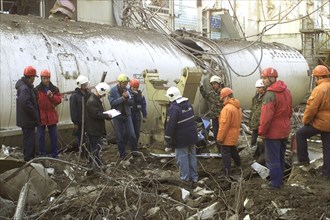 baikonur, kazakhstan: may 14 2002: workers clearing the fragments of 'energia' rocket carrier and first russian space shuttle 'buran' from debris of the destroyed roof of the assembly and test block w...
