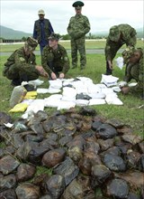 Russian borderguards on the tajik-afgan frontier - tajikistan , may 27, 2002, picture shows russian borderguards seized a large load of drugs from the trafficers on the tajik-afgan frontier, about 700...