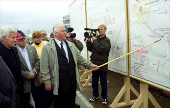 Kurgan region, russia, may 30 2002: zinovy pak, centre, director general of the russian munitions agency, showing to visiting delegation a plan of the shchuchye disposal facility, as a group of us sen...