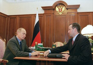 Kremlin, moscow, russia, june 19 2002: president of russia vladimir putin (l) and president of sberbank aleksey kazymin (r) discussed the sberbank performance in the year 2001 and preparations for the...