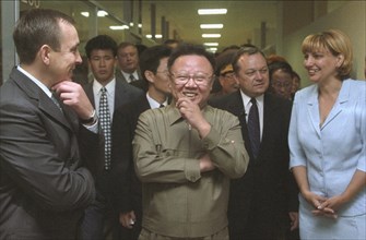 Visiting north korean leader kim jong-il (c) touring the trade complex 'ignat' accompanied by its executive director yelena kalinina (r) and vice-governor of russia's maritime territory igor ivanov (l...