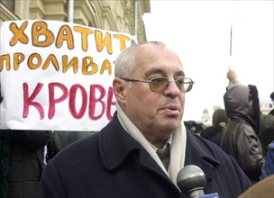Moscow, russia, october 25 2002: theater producer mark rozovsky pictured (against the background of the slogan 'stop bloodshed !') speaking at the meeting held near the st basil cathedral organized by...