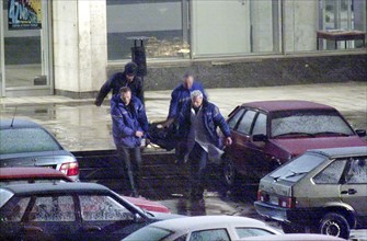 Moscow, russia,10/26/02: chechen hostage crisis: a dead body is carried out of the theater center, presumably it is the body of the man who entered the building tonight, probably a relative of a hosta...