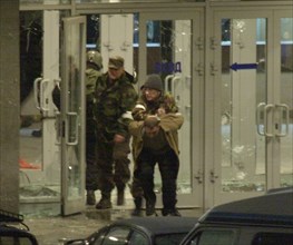 Moscow, russia,10/26/02: chechen hostage crisis: special forces personnel escort a terrorist out of the building, barayev and 35 terrorists including those with explosives attached to their bodies, we...