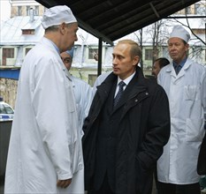 Moscow, russia,10/26/02: chechen hostage crisis: president vladimir putin (c) talks to doctors, president visited released hostages in need of medical attention who were taken to the sklifosovsky firs...