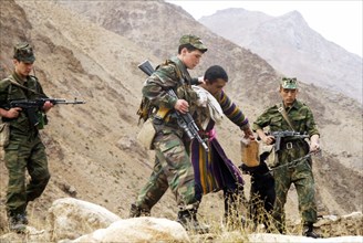 Tajikistan , november 13 2002: russian border guards on the tajik - afghan frontier pictured capturing of a trespasser (a resident of a tajik village localed near the border), the local population oft...