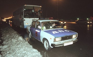 Moscow, russia, november 15 2002: tajik illegal immigrants in a bus escorted by a police car (in pic) on their way to chkalovsky airport for further deportation, the people's courts of khimki and podo...