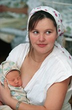 Chita, russia, 2001, viktoria kolobova with her new-born son kolya, now women in chita give birth to two or three babies while five years ago they could afford only one,  photo itar-tass/yevgeny yepac...