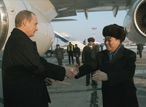 President of russia vladimir putin (left) being met by president of kyrgyzstan askar akayev (right) at bishkek airport, as putin arrived to kyrgyztan for a visit on thursday, dec, 5, 2002.