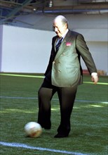 Minsk, belarus, december 8 2002: fifa president joseph blatter kicks a football (in pic) at a ceremony held on sunday to celebrate the opening of a football field with artificial covering, the field w...