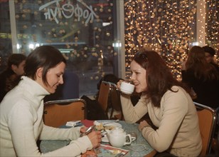 Two young moscow women drinking tea in a fashionable and expensive restaurant in moscow, russia, 2003.