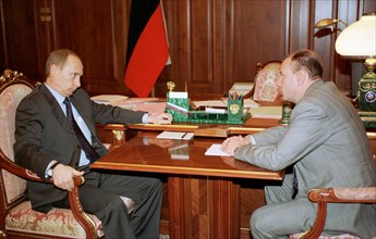 President vladimir putin (l) pictured talking with vladimir potanin, a prominent russian businessman who heads the interros holding company, on tuesday in the kremlin, december 24, 2002.