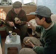 Chinese guest workers during a lunch break, in vladivostok, russia, january 28 2003, russian businessmen like to hire foreign citizens (chinese, vietnamese, north koreans) who agree to work under any ...